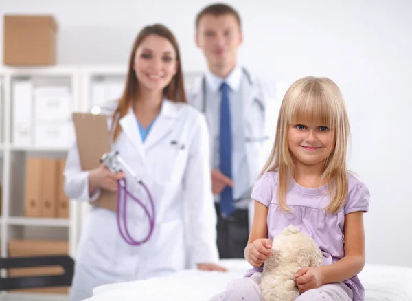 Female doctor examining child with stethoscope at surgery — Stock Photo, Image