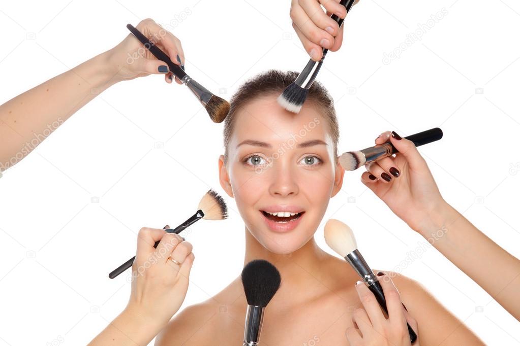 Closeup portrait picture of beautiful woman with brushes