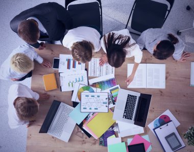 İş adamları iş toplantısında, ofiste oturup tartışıyorlar.