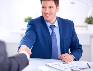 Business people shaking hands, finishing up a meeting clipart