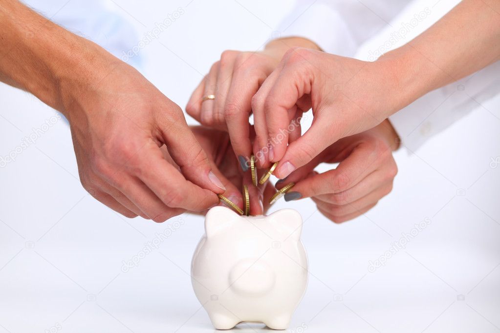 People putting coin into the piggy bank