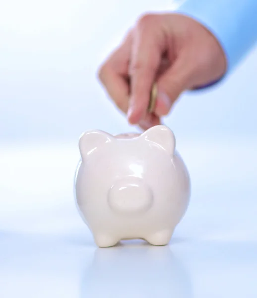 People putting coin into the piggy bank — Stock Photo, Image