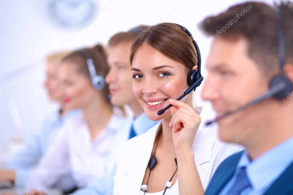 Attractive Smiling positive young businesspeople and colleagues in a call center office