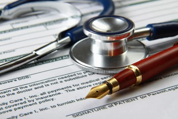 Stethoscope on medical billing statement on table, all text is anonymous — Stock Photo, Image