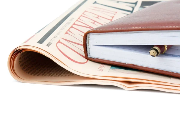 A diary and a fountain pen placed on a financial newspaper. — Stock Photo, Image