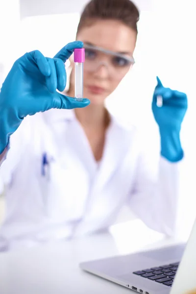 Woman researcher is surrounded by medical vials and flasks, isolated on white background — Stock Photo, Image