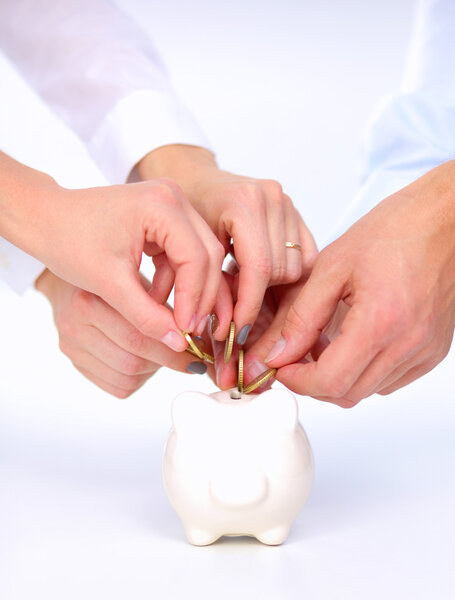 People putting coin into the piggy bank