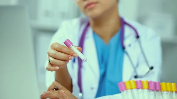 Mulher pesquisadora é cercada por frascos e frascos médicos, isolados em fundo branco — Fotografia de Stock