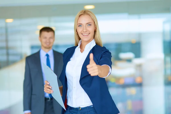 Happy business team showing thumbs up in office — Stock Photo, Image