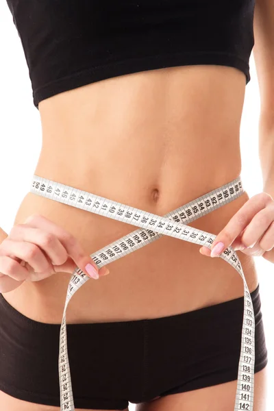 Woman measure her waist belly by metre-stick. Royalty Free Stock Images