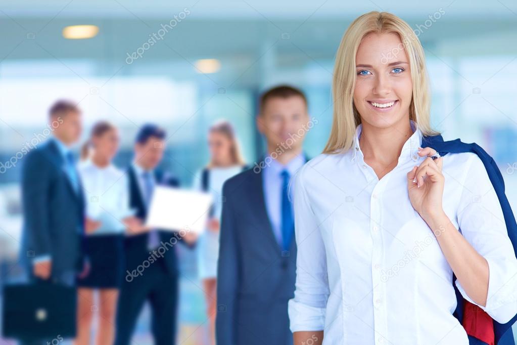Smiling successful business team standing in office