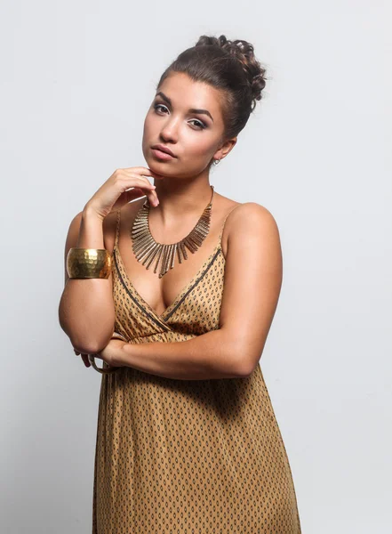 Young woman wearing a beige dress standing — Stock Photo, Image