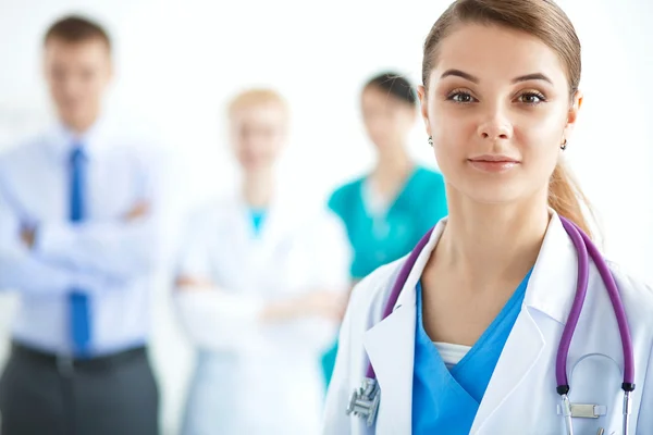 Attractive female doctor in front of medical group — Stock Photo, Image