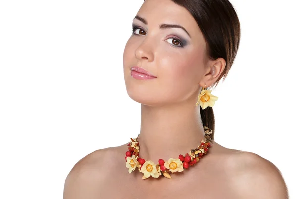 Portrait of young beautiful brunette woman in beads — Stock Photo, Image