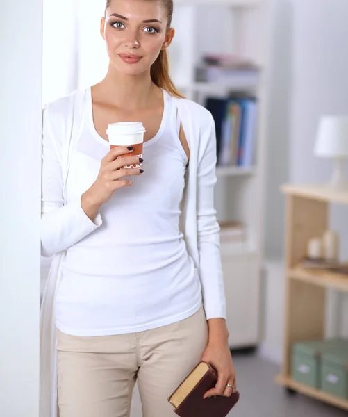 Attractive young businesswoman standing  near wall in office — Stock Photo, Image