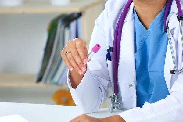 Woman researcher is surrounded by medical vials and flasks — Stock Photo, Image