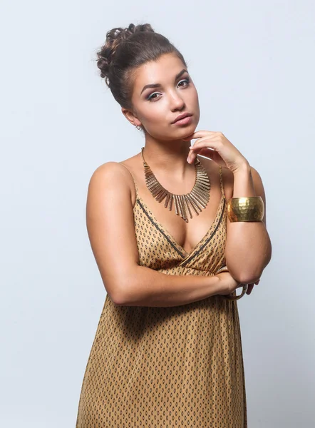 Young woman wearing a beige dress standing — Stock Photo, Image