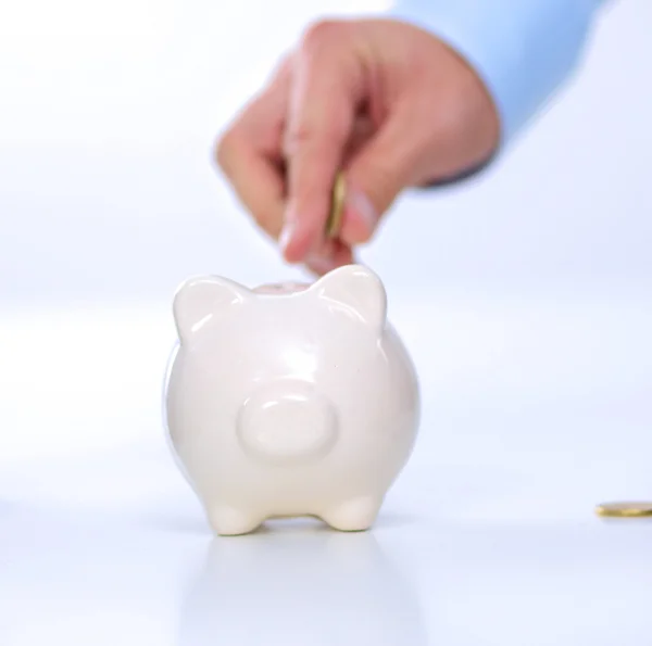 People putting coin into the piggy bank — Stock Photo, Image