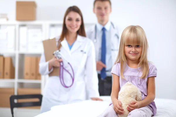 Female doctor examining child with stethoscope at surgery — Stock Photo, Image