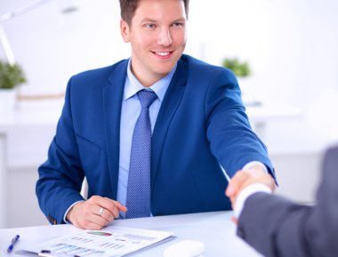 Business people shaking hands, finishing up a meeting clipart