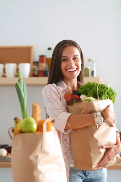 Junge Frau hält Einkaufstüte mit Gemüse — Stockfoto