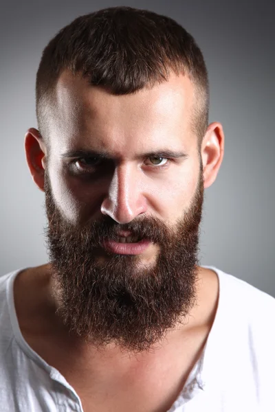 Portrait of handsome bearded man standing, isolated on grey background — Stock Photo, Image