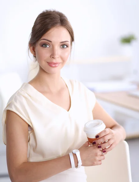 Attractive young businesswoman standing  near desk in office — Stock Photo, Image