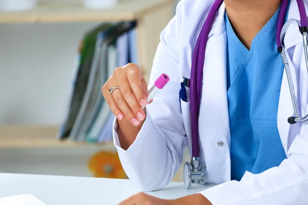 Woman researcher is surrounded by medical vials and flasks — Stock Photo, Image