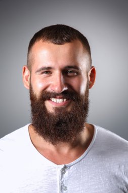 Ayakta, gri arka plan üzerinde izole yakışıklı adam portresi