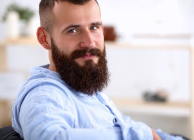 Genç işadamı koltukta oturuyor.