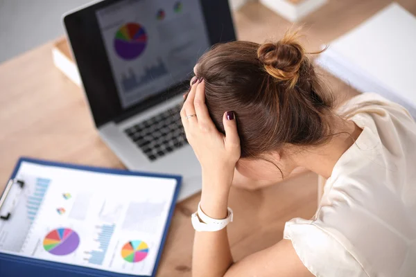 Portrait of tired young business woman with laptop computer at the office — Stock Photo, Image