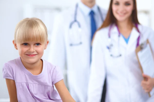 Female doctor examining child with stethoscope at surgery — Stock Photo, Image