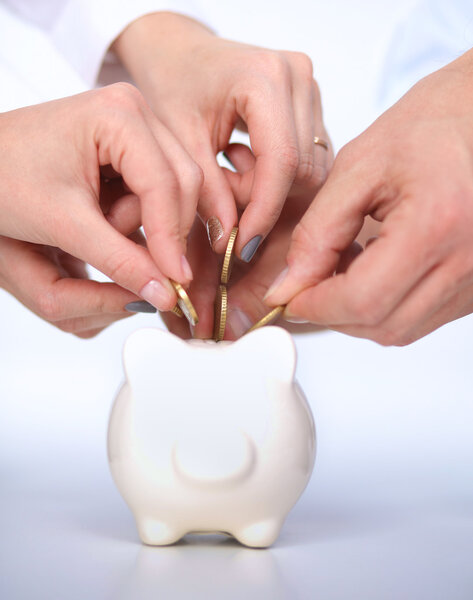 People putting coin into the piggy bank