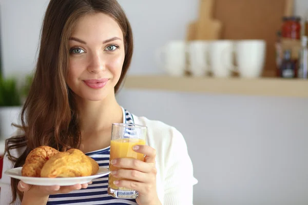 Junge Frau mit Glas Saft und Kuchen — Stockfoto