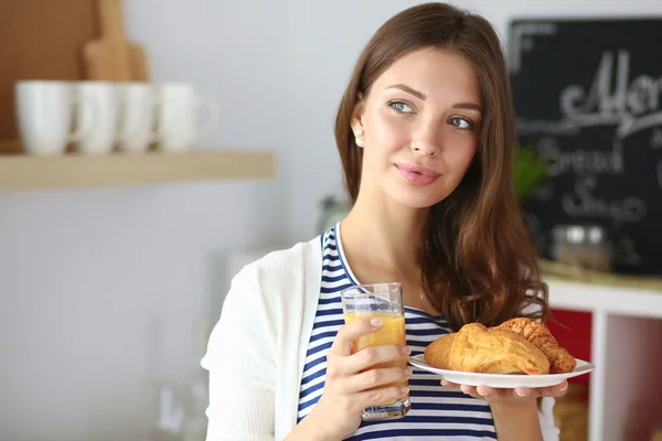 Mujer joven con vaso de jugo y pasteles —  Fotos de Stock