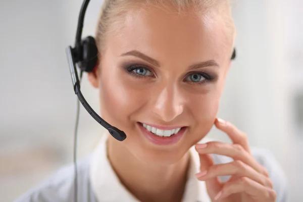 Close-up portrait of a customer service agent sitting at office — Stock Photo, Image