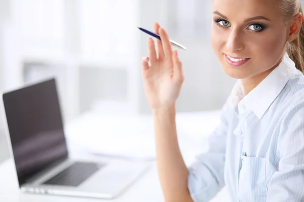 Attraente donna d'affari seduta su una scrivania con computer portatile in ufficio — Foto Stock