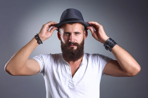 Portrait of handsome man in hat standing , isolated on grey background — Stock Photo, Image