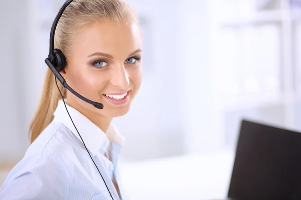 Close-up portrait of a customer service agent sitting at office Stock Picture