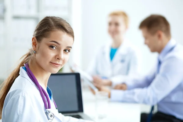 Medical team sitting at the table in modern hospital — Stock Photo, Image