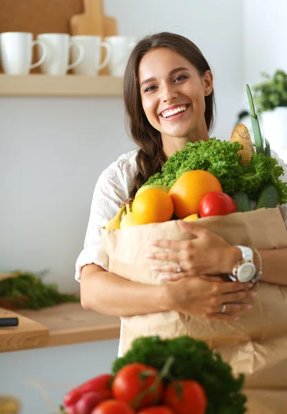 Junge Frau hält Einkaufstüte mit Gemüse — Stockfoto