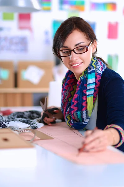 Dressmaker designing clothes pattern on paper — Stock Photo, Image