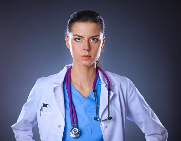 Jeune médecin femme avec stéthoscope isolé sur gris — Photo