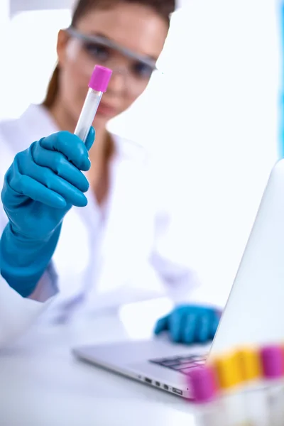 Woman researcher is surrounded by medical vials and flasks, isolated on white background — Stock Photo, Image