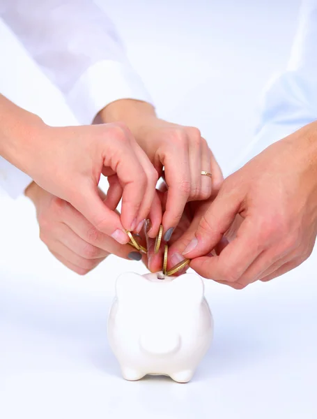 People putting coin into the piggy bank — Stock Photo, Image