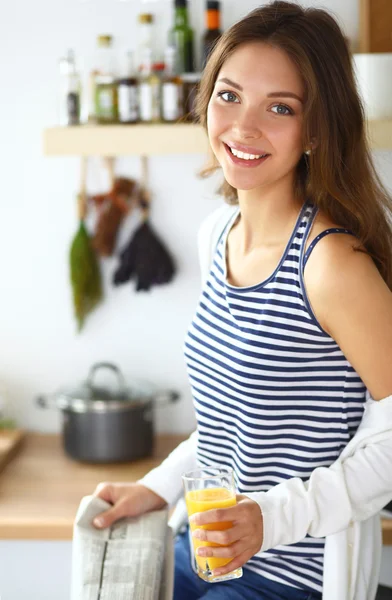 Porträtt av en vacker kvinna som sitter i köket — Stockfoto