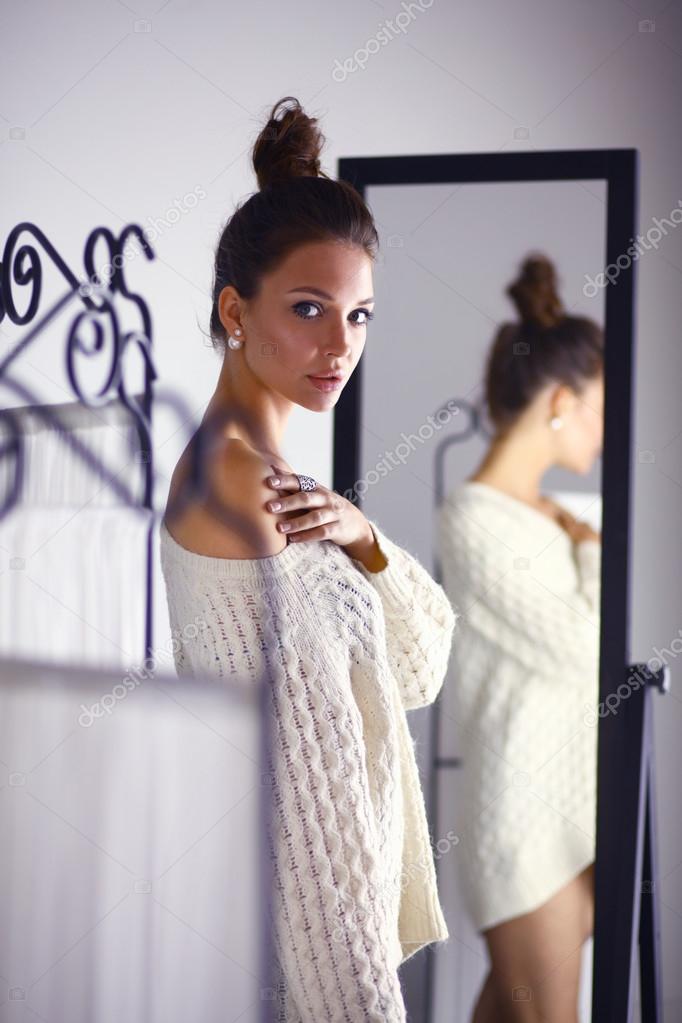 Portrait of a cute woman in sweater at home