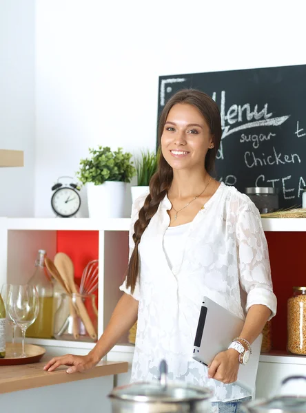 Giovane donna in piedi vicino alla scrivania in cucina — Foto Stock