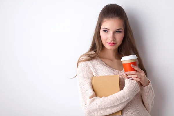 Portrait  a young woman with cup of tea or coffee, holding book — Stock Photo, Image