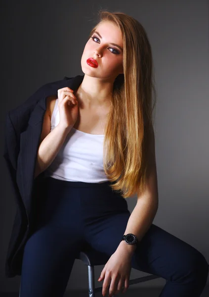 Young woman sitting on a chair — Stock Photo, Image